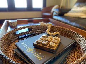 a wooden coffee table with a remote control on a book at Historic Downtown Flat, # 2 in Astoria, Oregon