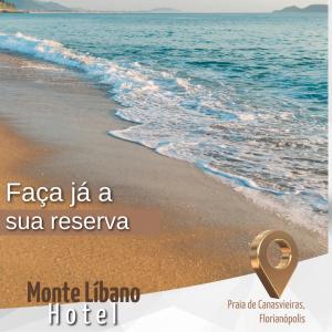 a picture of a beach with a gold ring on it at Monte Libano Apart Hotel in Florianópolis
