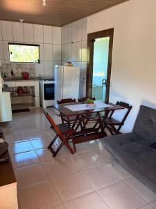 a kitchen with a table and chairs and a refrigerator at Casa Lumiar in Lumiar