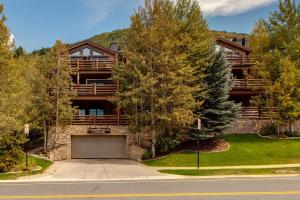 a large house with a garage in front of it at Luxury Condo Near Year-Round Recreation, Free Shuttle & Hot Tub! Deer Valley Comstock Lodge 302 in Park City