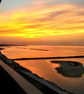 a sunset over a body of water with at Approdo Sul Mare Bari Apartment in Bari