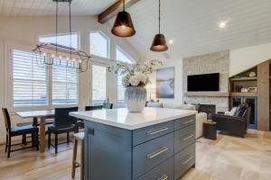 a kitchen and living room with a vase of flowers at Luxury Condo & Professional Design, Free Shuttle & Hot Tub! Deer Valley Comstock Lodge 307 in Park City