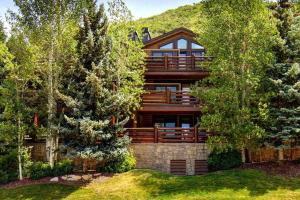a home with a large wooden house with trees at Luxury Condo & Professional Design, Free Shuttle & Hot Tub! Deer Valley Comstock Lodge 307 in Park City