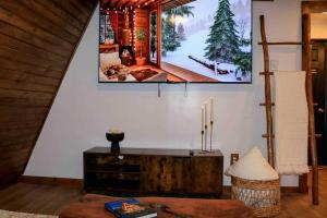 a living room with a tv hanging on the wall at The New Luxury Cabin PetFriendly Pocono Summit in Pocono Summit