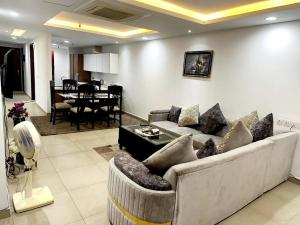 een woonkamer met een bank en een eetkamer bij 2 bed Apartment in Gold crest apartment in Lahore