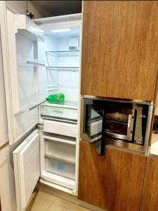 een keuken met een open koelkast en een broodrooster bij 2 bed Apartment in Gold crest apartment in Lahore