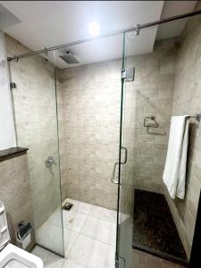 een badkamer met een douche en een glazen deur bij 2 bed Apartment in Gold crest apartment in Lahore