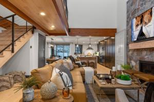 a living room with a couch and a fireplace at Enjoy a Modern Luxury Design, Central Location, Hot Tub & Recreation! Deer Valley Fawngrove 1674 in Park City