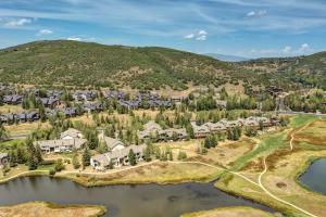 an aerial view of a home with a lake at Enjoy a Modern Luxury Design, Central Location, Hot Tub & Recreation! Deer Valley Fawngrove 1674 in Park City