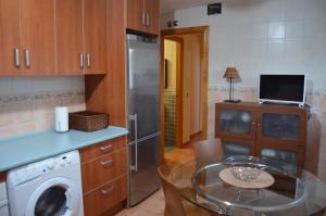 a kitchen with a glass table and a kitchen with a washer at Ojaranzo in Candeleda +12 photos