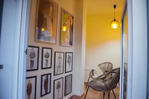 a hallway with a bunch of pictures on a wall at Ojaranzo in Candeleda