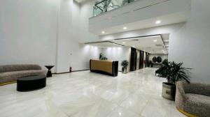 a large lobby with couches and chairs in a building at Premium&Cozy Studio DHA Lahore in Lahore