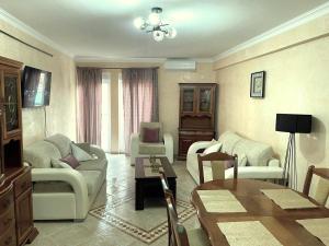 a living room with two couches and a table at Apartments Marina in Rafailovici