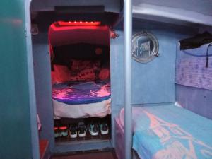 a small room with a bunk bed with shoes in it at Séjour sur voilier in Antibes