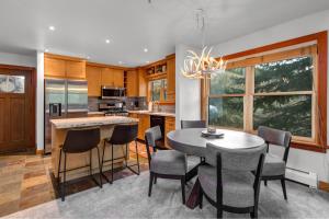 a kitchen with a table and chairs and a dining room at Unbeatable Location, Year-Round Recreation & Private Hot Tub! Deer Valley Greyhawk 14 in Park City