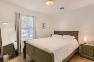 a bedroom with a large bed and a window at Hidden Gem near F1! 3bd/2bath - Private Backyard! in Austin