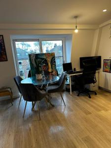an office with a table and chairs and a desk at Beckenham- PRIVATE DOUBLE Bedroom With En-suite in SHARED APARTMENT in Elmers End