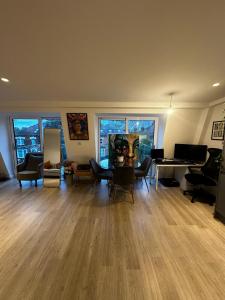 an empty living room with a table and chairs at Beckenham- PRIVATE DOUBLE Bedroom With En-suite in SHARED APARTMENT in Elmers End