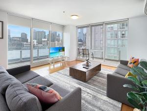 a living room with a view of a city at 3 BR 2 Bath 2 Carparks next to Crown Casino in Melbourne