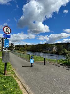 a parking meter on the side of a road next to a river at Ben Lomond Apartment in Alexandria