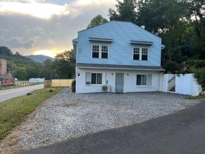 a blue house sitting on the side of a road at The Bait & Tackle - Newly renovated suite apt 2 in Bryson City