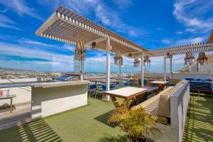 a patio with tables and chairs and a view of the city at Cabo Cove 408 B in Cabo San Lucas