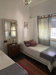 A bed or beds in a room at La Casita de Bogado
