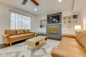 a living room with two couches and a fireplace at Family-Friendly Home 6 Mi to Downtown Mobile! in Mobile
