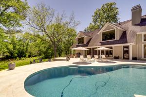 a swimming pool in front of a house at Private Estate on 25 Acres Fishing and Canoeing! in Houston