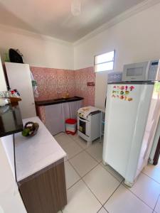 a kitchen with a refrigerator and a stove at Apartamento em Ilha De Itamaracá in Vila Velha