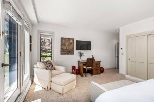 a bedroom with a bed and a chair and a desk at Homestead Townhome in Snowmass Village +42 photos