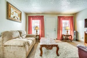 a living room with a couch and a coffee table at Convenient Harvey Apt - 12 Mi to French Quarter! in Harvey
