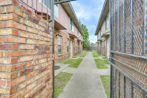 an alley between two brick buildings at Convenient Harvey Apt - 12 Mi to French Quarter! in Harvey