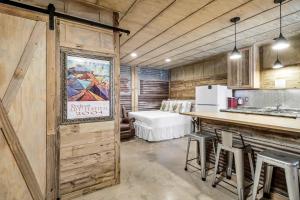 a kitchen with a bar and stools in a room at Casas Coastal Experience Cabin A in Rockport