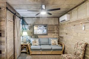 a living room with a couch and a ceiling fan at Casas Coastal Experience Cabin C in Rockport
