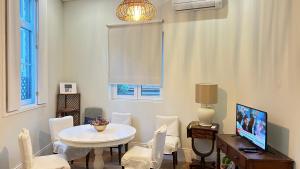 une salle à manger avec une table et des chaises blanches dans l'établissement Chalé Caldas de Aregos, à Caldas de Aregos