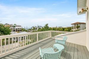 two chairs on a balcony with a view of the ocean at Blue Mountain Home with 2 Masters and a Private Pool while only 300 ft to Beach in Santa Rosa Beach