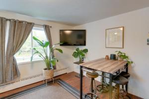 a living room with a table and a window at Cozy Anchorage Retreat Less Than 4 Mi to Downtown! in Anchorage