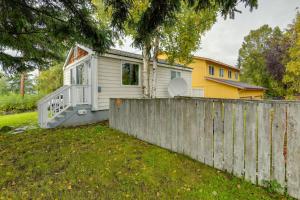 a tiny house behind a fence in a yard at Cozy Anchorage Retreat Less Than 4 Mi to Downtown! in Anchorage