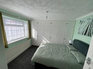 a bedroom with a bed and a window at Stunning 4-Bed House in Rochester in Rochester