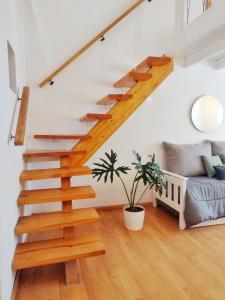 escalera en la sala de estar con sofá en Loft ACACIAS III en Cipolletti