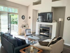 a living room with a couch and a fireplace at Top Choice Family Vacation House Walkable to Shops in Cary