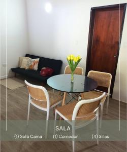 a table and chairs with a vase of flowers on it at Casa Wadara in La Mira