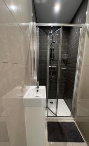 y baño con ducha y lavamanos. en Lovely Home in Kimmage, Dublin en Dublín