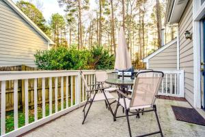 a patio with two chairs and an umbrella at Top Choice Family Vacation House Walkable to Shops in Cary