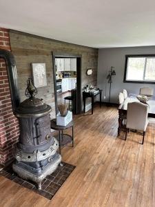 a living room with a wood stove in a room at Huge Secluded 5 Bedroom 2 12 Bathroom Home! in Ontario