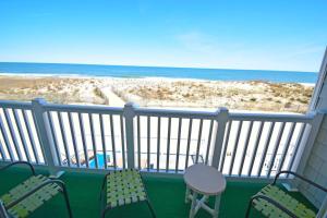 a balcony with chairs and a view of the beach at Ocean Club 4011 townhouse in Ocean City