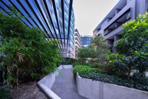 a walkway in the middle of a building with plants at Asteroid B-612 Urban Bliss Retreat in Melbourne