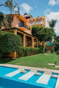 a house with a swimming pool in front of it at Villa Casalet in Puerto Escondido