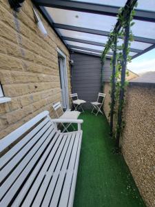 a bench sitting on the side of a building at Fern House - free off road parking included in Buxton